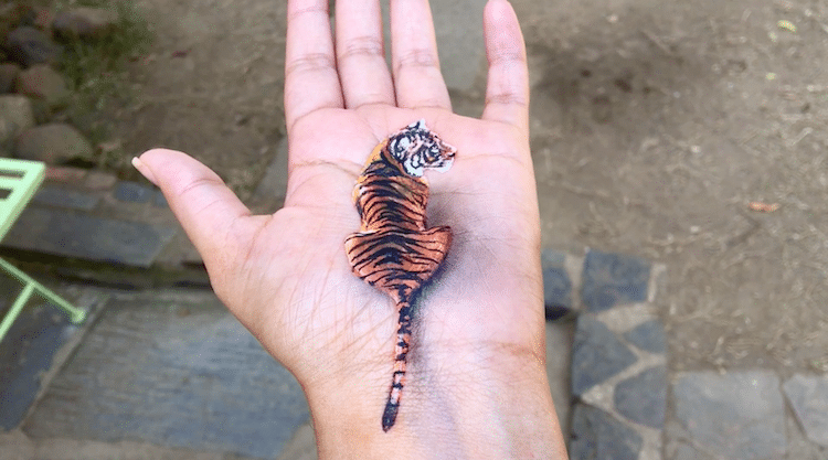 Tiger painted on a hand