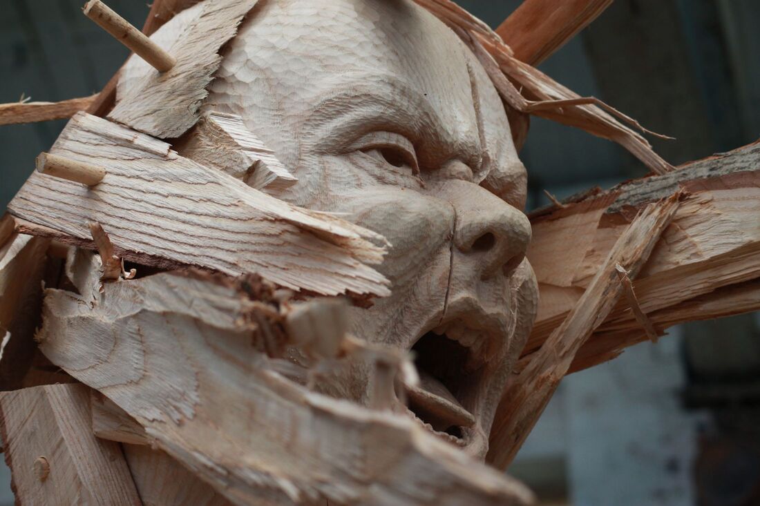 emotional face in wooden sculpture